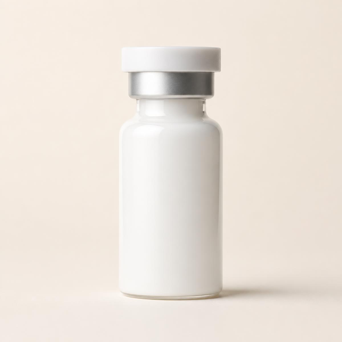 Unbranded white pharmaceutical vial on an ivory background